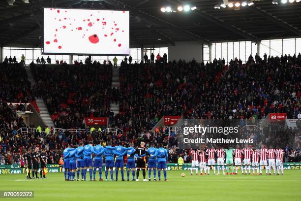 Players line up for a minute's silence ahead of Remembrance Sunday prior to the Premier League match between Stoke City and Leicester City at Bet365...