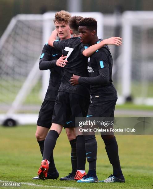 Charlie Brown of Chelsea celebrates with team mates Daishawn Redan and Billy Gilmour after he scores to make it 3-0 during a Premier League Cup match...