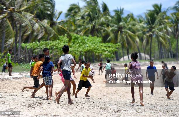 Young children play Rugby League on the beach in Tubusereia Village on November 4, 2017 in Tubusereia, Central Province, Papua New Guinea.
