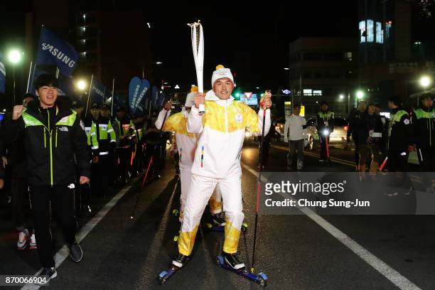 Torch bearer Kim Magnus holds the PyeongChang 2018 Winter Olympics torch during the PyeongChang 2018 Winter Olympic Games torch relay on November 4,...