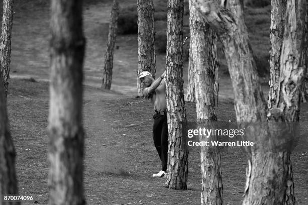 Lee Westwood of England plays out of the trees on the 15th hole during the third round of the Turkish Airlines Open at the Regnum Carya Golf & Spa...