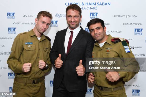 Gerard Butler with IDF Staff Sgt. Nathan and IDF Staff Sgt. Maor at the FIDF Western Region Gala at The Beverly Hilton Hotel on November 2, 2017 in...