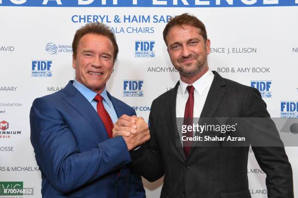 Arnold Schwarzenegger and Gerard Butler at the FIDF Western Region Gala at The Beverly Hilton Hotel on November 2, 2017 in Beverly Hills, California.