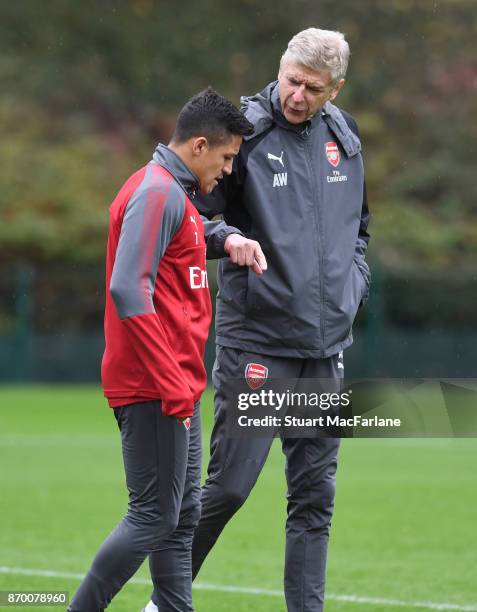 Arsenal manager Arsene Wenger talks to Alexis Sanchez during a training session at London Colney on November 4, 2017 in St Albans, England.