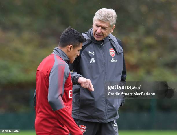 Arsenal manager Arsene Wenger talks to Alexis Sanchez during a training session at London Colney on November 4, 2017 in St Albans, England.