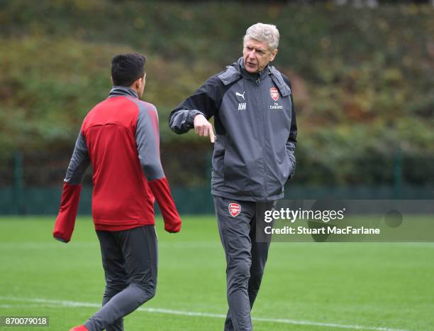 Arsenal manager Arsene Wenger talks to Alexis Sanchez during a training session at London Colney on November 4, 2017 in St Albans, England.