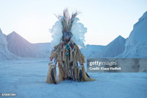 man wearing amazing witch doctor inspired hybrid costume with old computer parts - shaman stock-fotos und bilder