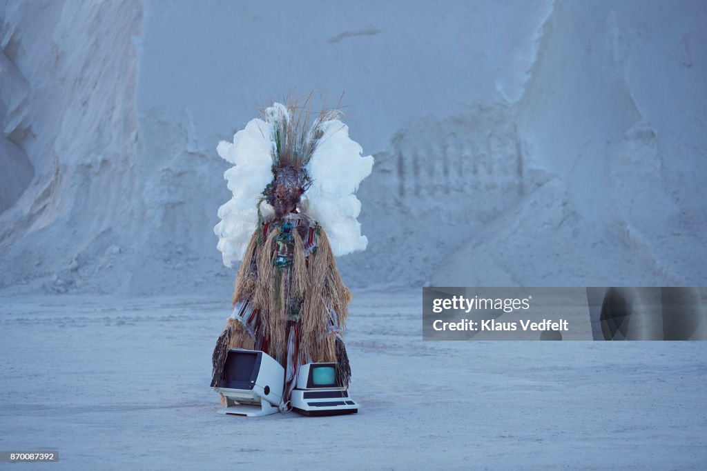 Man wearing amazing witch doctor inspired hybrid costume with old computer parts