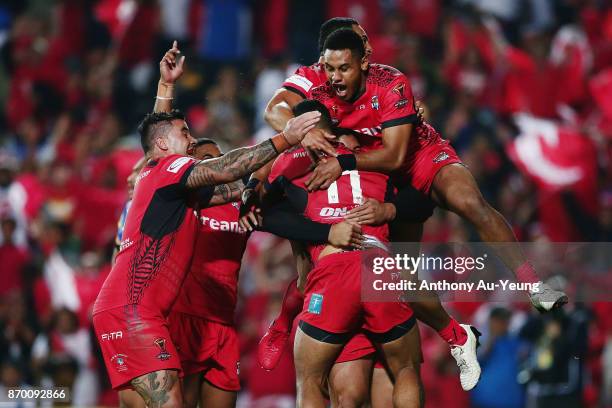 Manu Ma'u of Tonga is mobbed by teammates after scoring a try during the 2017 Rugby League World Cup match between Samoa and Tonga at Waikato Stadium...