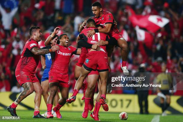 Manu Ma'u of Tonga is mobbed by teammates after scoring a try during the 2017 Rugby League World Cup match between Samoa and Tonga at Waikato Stadium...