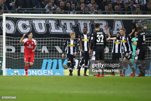 Yoshinori Muto of Mainz celebrates after Abdou Diallo of Mainz scored a goal to make it 0:1 during the Bundesliga match between Borussia...