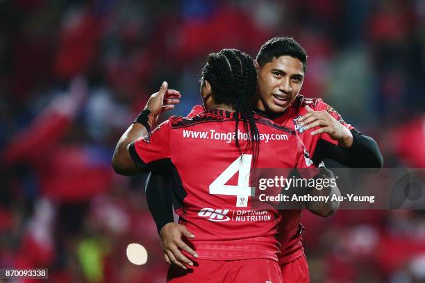 Jason Taumalolo of Tonga celebrates with teammate Solomone Kata after winning the 2017 Rugby League World Cup match between Samoa and Tonga at...