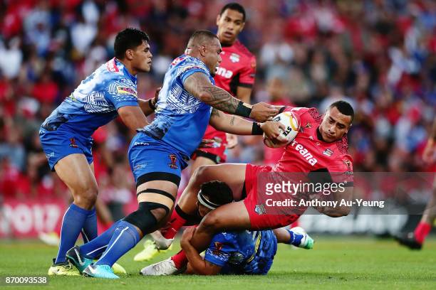 Sio Siua Taukeiaho of Tonga is tackled by Junior Paulo of Samoa during the 2017 Rugby League World Cup match between Samoa and Tonga at Waikato...