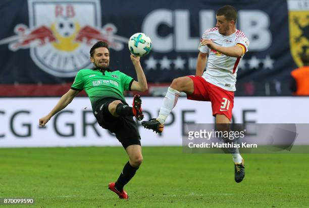 Diego Demme of Leipzig battles for the ball with Julian Korb of Hannover during the Bundesliga match between RB Leipzig and Hannover 96 at Red Bull...