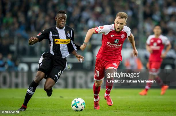 Denis Zakaria of Borussia Moenchengladbach and Alexandru Maxim of FSV Mainz 05 battle for the ball during the Bundesliga match between Borussia...