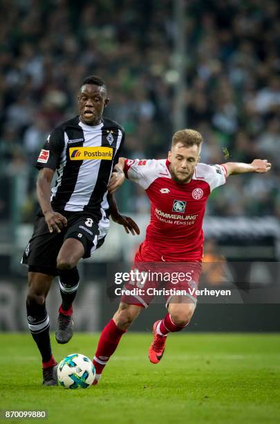 Denis Zakaria of Borussia Moenchengladbach and Alexandru Maxim of FSV Mainz 05 battle for the ball during the Bundesliga match between Borussia...