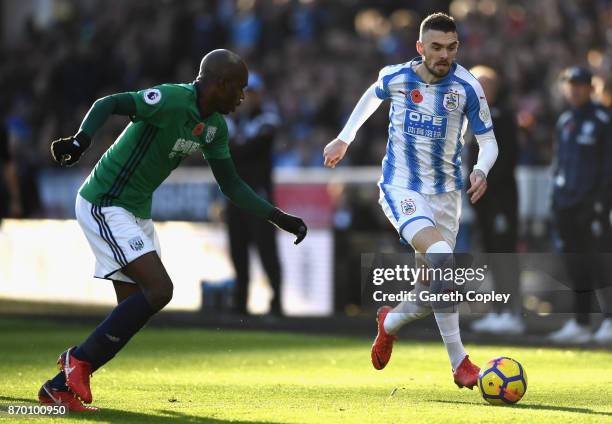 Scott Malone of Huddersfield Town takes on Allan Nyom of West Bromwich Albion during the Premier League match between Huddersfield Town and West...
