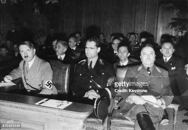 From left to right, Nazi Party officials Adolf Hitler, Rudolf Hess and Robert Ley at the first Congress of National Labour in the chamber of the...