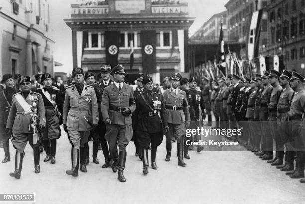 Nazi Party deputy leader Rudolf Hess inspects a Guard of Honour upon his arrival in Rome, Italy, 29th October 1939. On either side of him are Italian...