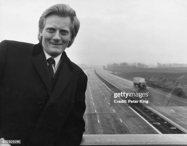 Michael Heseltine, the Parliamentary Secretary of State to the Department of the Environment, on a bridge over the new M4 motorway at the Badbury...