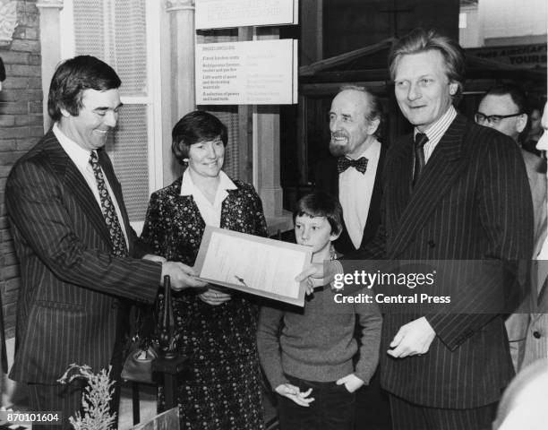 Michael Heseltine , the Secretary of State for the Environment, hands over the deeds to the GLC's 25,000th home buyer, schoolteacher Peter McCarthy,...