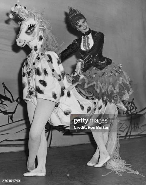 British ballerina Margaret Hill riding on a pantomime horse during rehearsals for the Sadler's Wells Ballet Company production 'Carte Blanche', to be...