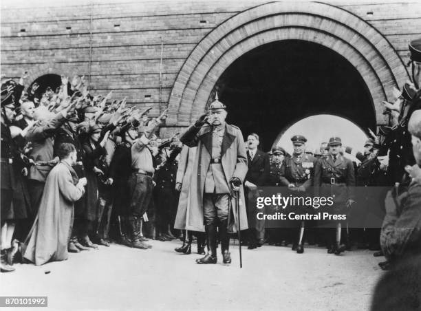 President of the German Reich Paul von Hindenburg , followed by Nazi Party officials Adolf Hitler, Hermann Goering and Ernst Röhm, circa 1933.