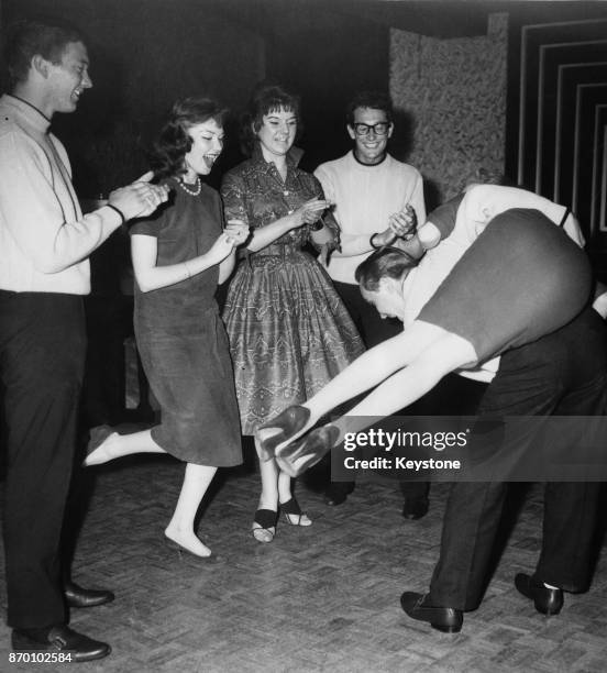 American rock and roll band The Crickets jiving in London during a three-week tour of the UK, 1958. They are Jerry Allison , Buddy Holly and Joe B....