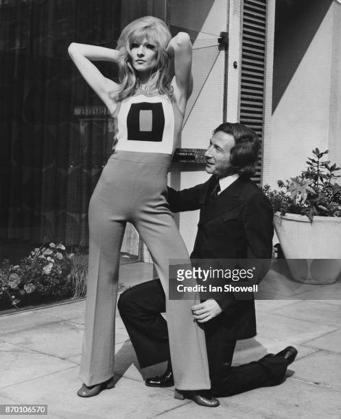 English actress and model Vicki Hodge with French fashion designer Ted Lapidus at Tricoville on Great Portland Street, London, where Lapidus is...