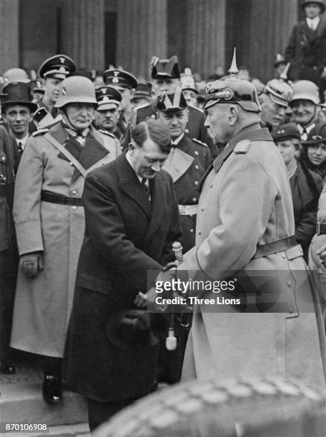 German Nazi Party leader Adolf Hitler meets German President Paul von Hindenburg after Hitler's appointment as Chancellor, 1933. Behind Hitler are...