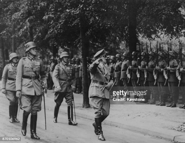 German Chancellor Adolf Hitler with German Defence Minister and General Werner von Blomberg during a military inspection, 6th August 1934.
