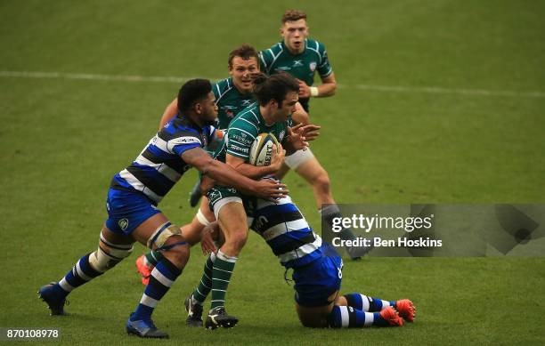 Luke McLean of London Irish is tackled by Levi Douglas and Ben Tapuai of Bath during the Anglo-Welsh Cup between London Irish and Bath at Madejski...