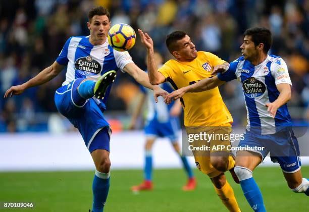 Atletico Madrid's Argentinian midfielder Angel Correa vies with Deportivo La Coruna's Swiss defender Fabian Schar and Deportivo La Coruna's Spanish...