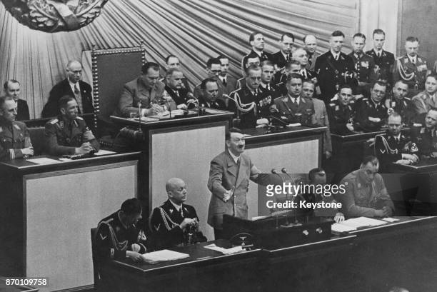 German Chancellor Adolf Hitler addresses the Reichstag in Berlin, Germany, 1939. Also pictured are Hermann Goering, Otto Dietrich, Wilhelm Brückner,...