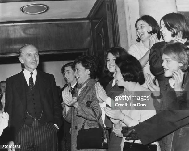 Outgoing British Prime Minister Alec Douglas-Home is cheered by supporters outside the Conservative Party headquarters in London, after submitting...