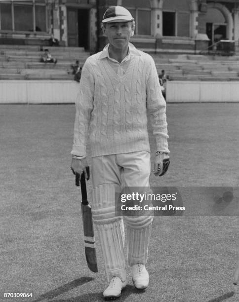 British politician Alec Douglas-Home , Lord Dunglass, goes out to bat for the Lords and Commons team during a cricket match at the Oval in London,...