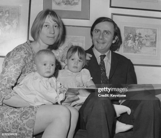 Australian comedian Barry Humphries, known for his alter ego Dame Edna Everage, with his wife Rosalind and their daughters Tessa and Emily, July 1965.