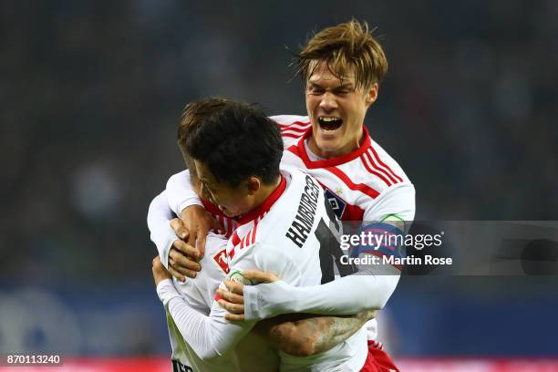 Gotoku Sakai of Hamburg , Tatsuya Ito of Hamburg and Dennis Diekmeier of Hamburg after Filip Kostic of Hamburg scored a goal to make it 2:1 during...