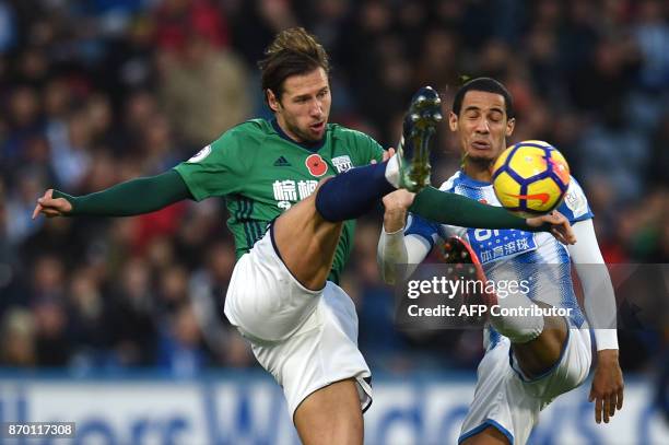 West Bromwich Albion's Polish midfielder Grzegorz Krychowiak vies with Huddersfield Town's Danish defender Mathias Jorgensen during the English...