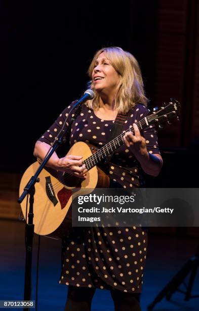 American musician Rickie Lee Jones plays acoustic guitar as she performs onstage during 'An Intimate Evening with Rickie Lee Jones,' part of the Late...