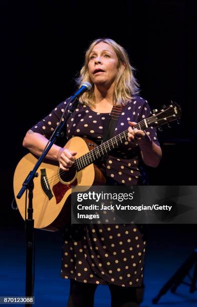 American musician Rickie Lee Jones plays acoustic guitar as she performs onstage during 'An Intimate Evening with Rickie Lee Jones,' part of the Late...