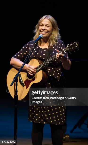 American musician Rickie Lee Jones plays acoustic guitar as she performs onstage during 'An Intimate Evening with Rickie Lee Jones,' part of the Late...