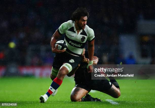 Steven Luatua of the Barbarians is tackled by Ofa Tu'ungafasi of New Zealand during the Killik Cup match between Barbarians and New Zealand at...