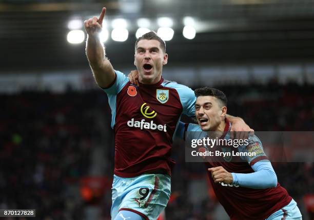 Sam Vokes celebrates scoring his side's first goal with Matthew Lowton of Burnley during the Premier League match between Southampton and Burnley at...