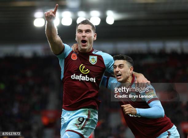 Sam Vokes celebrates scoring his side's first goal with Matthew Lowton of Burnley during the Premier League match between Southampton and Burnley at...