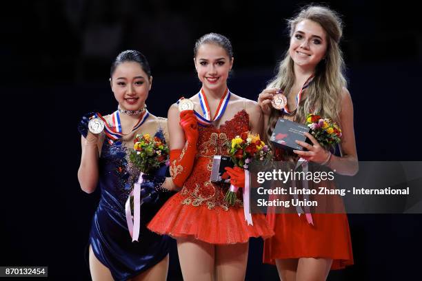 First place winner Alina Zagitova of Russia , second place winner Wakaba Higuchi of Japan and third place winner Elena Radionova of Russia pose on...