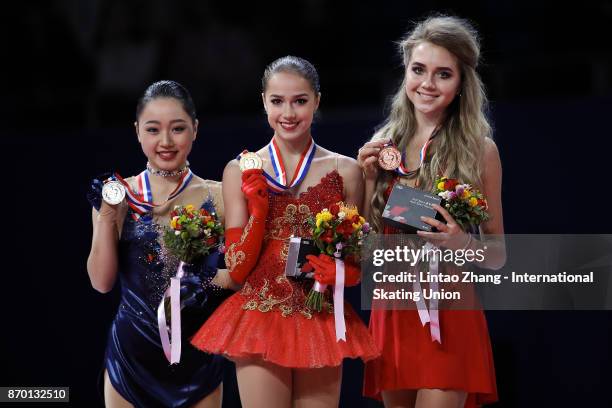 First place winner Alina Zagitova of Russia , second place winner Wakaba Higuchi of Japan and third place winner Elena Radionova of Russia pose on...