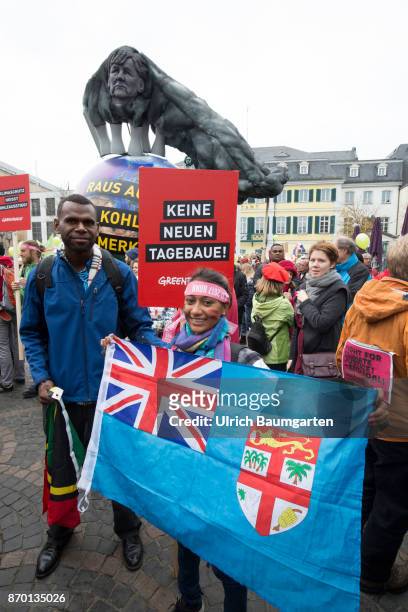 Big demonstration on the occasion of the UN Climate Conference in Bonn. Young girl from the Fiji islands with the flag of the Fiji's.