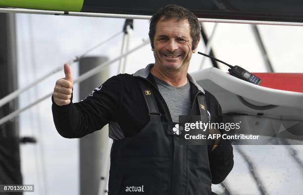 French skipper Yves Le Blevec aboard the multihull Team Actual gestures prior to his start for a record around the world westward on November 4, 2017...