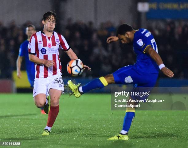 Lincoln City's Alex Woodyard closes down AFC Wimbledon's Andy Barcham during the Emirates FA Cup First Round match between A.F.C. Wimbledon and...